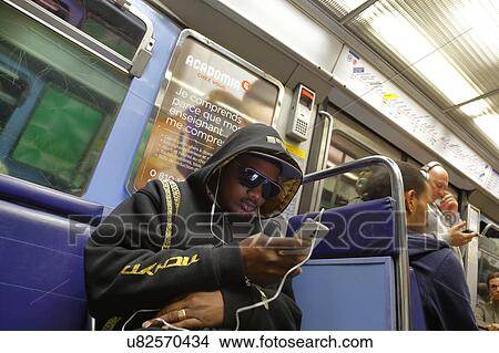Black Frenchman looks into Apple iphone on Metro Train, Paris, France View Large Photo Image Picture - Black Frenchman looks into Apple iphone on Metro Train, Paris, France. Fotosearch