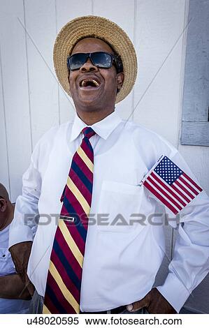 Stock Photography - Blackman with US Flag smiles at Joe Biden Rally, Las Vegas, NV.. Fotosearch