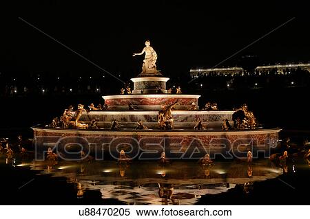 Stock Photography -  Chateau de Versailles at night with lights, the estate of Versaille was the home and court of Louis XIV, France. Fotosearch