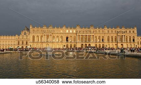 Stock Photo -  Chateau de Versailles at sunset with fountain, the estate of Versaille was the home and court of Louis XIV, France. Fotosearch