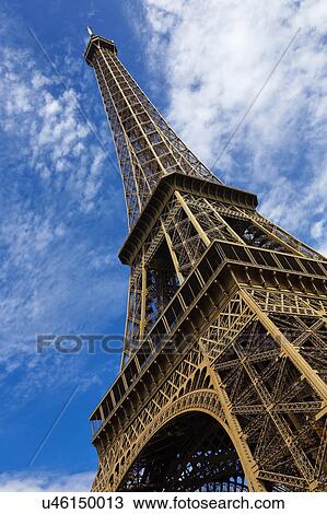 Stock Image - Eiffel Tower & blue sky with clouds, Paris, France. Fotosearch