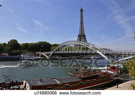 Eiffel Tower & blue sky with clouds, Paris, France - view from water with arched bridge over River Seine View Large Photo Image Stock Photo - Eiffel Tower & blue sky with clouds, Paris, France - view from water with arched bridge over River Seine. Fotosearch