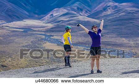 Stock Photograph - Females mountain biking at Polychrome Pass, Denali National Park, Interior, Alaska. Fotosearch