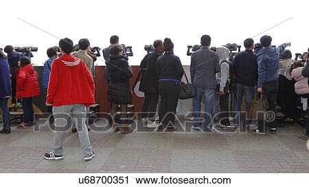 Group of tourist look through telescope at the Imjingak peace park in Paju near the demilitarized zone (DMZ) View Large Photo Image Stock Image - Group of tourist look through telescope at the Imjingak peace park in Paju near the demilitarized zone (DMZ). Fotosearch