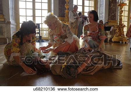 Stock Photograph - Historical reenactors at the Chateau de Versailles, the estate of Versaille was the home and court of Louis XIV, France. Fotosearch