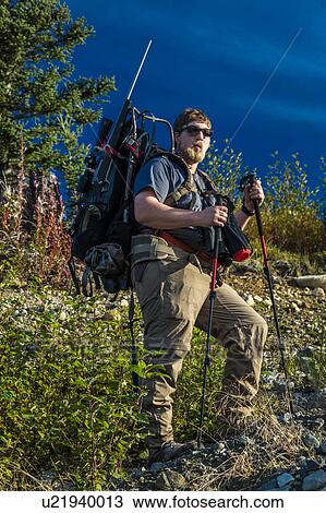 Hunter backpacks into wilderness with supplies and gun, Denali State Park, Alaska View Large Photo Image Stock Image - Hunter backpacks into wilderness with supplies and gun, Denali State Park, Alaska. Fotosearch