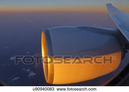 Jet Engine shot at sunset from passenger window View Large Photo Image Stock Image - Jet Engine shot at sunset from passenger window. Fotosearch