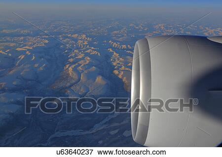 Stock Photo - Jet Engine shot at sunset from passenger window. Fotosearch