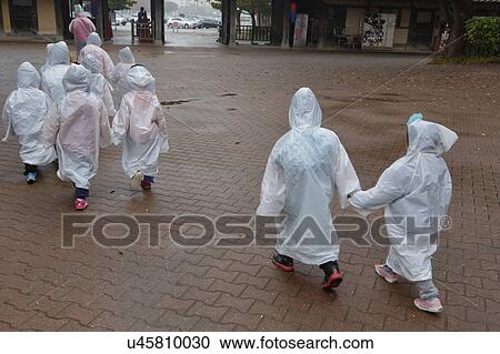 Korean students walk in rain in autumn color at Namsangol traditional folk village, Seoul, South Korea View Large Photo Image Stock Image - Korean students walk in rain in autumn color at Namsangol traditional folk village, Seoul, South Korea. Fotosearch