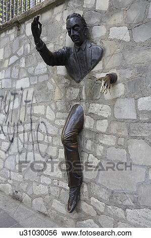 Stock Photograph - Le Passe-Muraille is the title of a story by Marcel Aymé about a man named Dutilleul who discovers that he can walk through walls, Montmartre Paris, France. Fotosearch