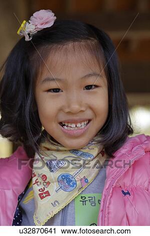 Stock Image - Little girl in pink at Namsangol traditional folk village, Seoul, South Korea. Fotosearch