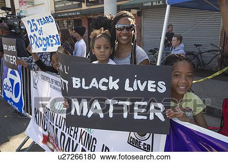 Stock Image - Los Angeles, California, USA, January 19, 2015, 30th annual Martin Luther King Jr. Kingdom Day Parade, women hold sign Black Lives Matter. Fotosearch