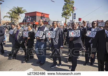Stock Photograph - Los Angeles, California, USA, January 19, 2015, 30th annual Martin Luther King Jr. Kingdom Day Parade, men hold signs Black Lives Matter. Fotosearch