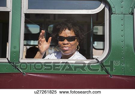 Stock Photography - Los Angeles, California, USA, January 19, 2015, 30th annual Martin Luther King Jr. Kingdom Day Parade, black woman in retro city bus. Fotosearch