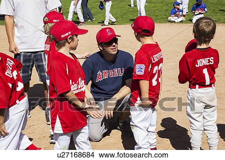 Oak View, California, USA, March 7, 2015, Ojai Valley Little League Field, youth Baseball, Spring, coach speaks to Tee-Ball Division players View Large Photo Image Picture - Oak View, California, USA, March 7, 2015, Ojai Valley Little League Field, youth Baseball, Spring, coach speaks to Tee-Ball Division players. Fotosearch