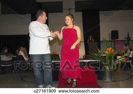 Stock Photo - Oak View, California, USA, March 7, 2015, Miss Oak View Pageant of Excellence, Teenage Beauty Contest, father escorts daughter downrunway. Fotosearch