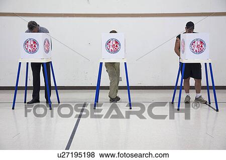 Stock Photo - Oak View, California, USA, November 4, 2014, citizen votes in election booth polling station in gymnasium. Fotosearch