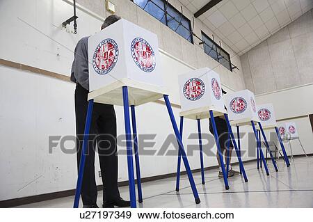 Stock Photo - Oak View, California, USA, November 4, 2014, citizen votes in election booth polling station in gymnasium. Fotosearch