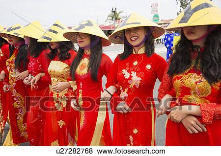 Stock Photo - Orange County, City of Westminster, Southern California, USA, February 21, 2015, Little Saigon, Vitenamese-American Community, TET Parade celebrates Tet Lunar New Year, women in cultural red dresses. Fotosearch