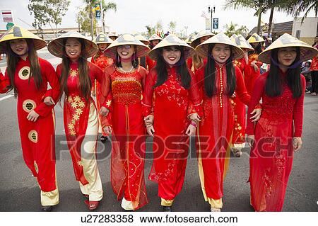 Orange County, City of Westminster, Southern California, USA, February 21, 2015, Little Saigon, Vitenamese-American Community, TET Parade celebrates Tet Lunar New Year, women in cultural red dresses View Large Photo Image Stock Photo - Orange County, City of Westminster, Southern California, USA, February 21, 2015, Little Saigon, Vitenamese-American Community, TET Parade celebrates Tet Lunar New Year, women in cultural red dresses. Fotosearch
