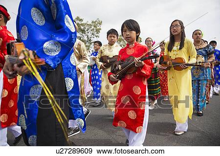 Stock Photo - Orange County, City of Westminster, Southern California, USA, February 21, 2015, Little Saigon, Vitenamese-American Community, TET Parade celebrates Tet Lunar New Year, marching violin players. Fotosearch