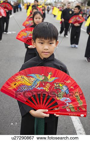 Stock Photo - Orange County, City of Westminster, Southern California, USA, February 21, 2015, Little Saigon, Vitenamese-American Community, TET Parade celebrates Tet Lunar New Year, you boy with decorative fan. Fotosearch
