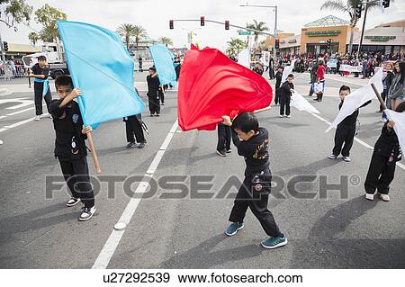 Stock Photo - Orange County, City of Westminster, Southern California, USA, February 21, 2015, Little Saigon, Vitenamese-American Community, TET Parade celebrates Tet Lunar New Year, young boy with flag. Fotosearch