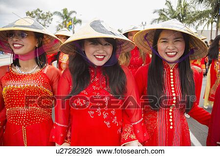 Stock Photograph - Orange County, City of Westminster, Southern California, USA, February 21, 2015, Little Saigon, Vitenamese-American Community, TET Parade celebrates Tet Lunar New Year, women in cultural red dresses. Fotosearch