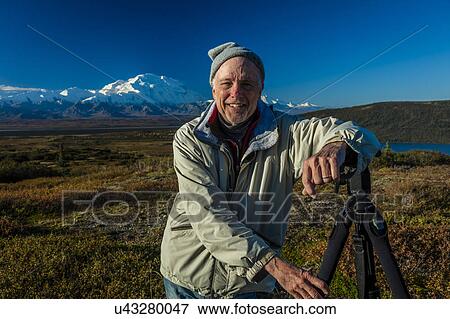 Photographer Joe Sohm tripod poses at famous Ansel Adams picture spot, Wonder Lake, Mount Denali, Kantishna, Alaska View Large Photo Image Stock Photo - Photographer Joe Sohm tripod poses at famous Ansel Adams picture spot, Wonder Lake, Mount Denali, Kantishna, Alaska. Fotosearch