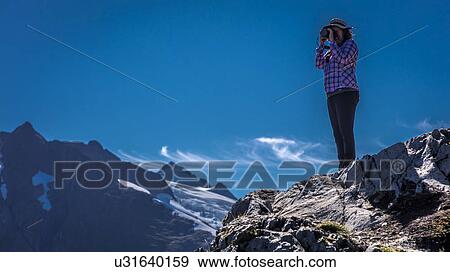 Stock Photo - Photographer shooting pictures near Portage Glacier, Alaska. Fotosearch