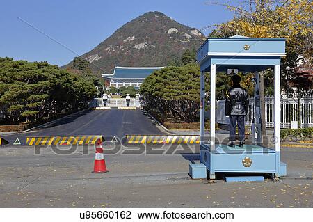 Policeman on watch at the main entrance of Cheongwadae (Blue House / Pavilion of Blue Tiles) - Seoul, South Korea View Large Photo Image Stock Image - Policeman on watch at the main entrance of Cheongwadae (Blue House / Pavilion of Blue Tiles) - Seoul, South Korea. Fotosearch