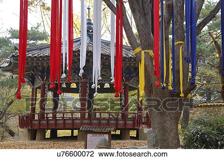 Stock Image - Prayer ribbons in autumn color at Namsangol traditional folk village, Seoul, South Korea. Fotosearch