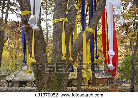 Stock Image - Prayer ribbons in autumn color at Namsangol traditional folk village, Seoul, South Korea. Fotosearch