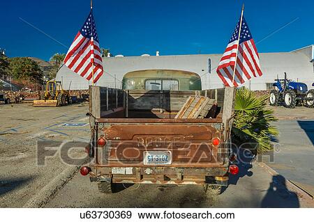 Stock Photo - Red Dodge Pickup truck parked in front of vintage gas station in Santa Paula, California. Fotosearch