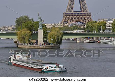 Replica of the Statue of Liberty and Eiffel Tower with tourboat on River Seine - Paris, France View Large Photo Image Stock Image - Replica of the Statue of Liberty and Eiffel Tower with tourboat on River Seine - Paris, France. Fotosearch