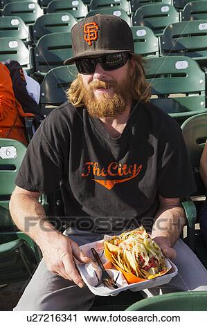 Stock Image - San Francisco, California, USA, October 16, 2014, AT&T Park, baseball stadium, SF Giants versus St. Louis Cardinals, National League Championship Series (NLCS), fan with hot dog. Fotosearch