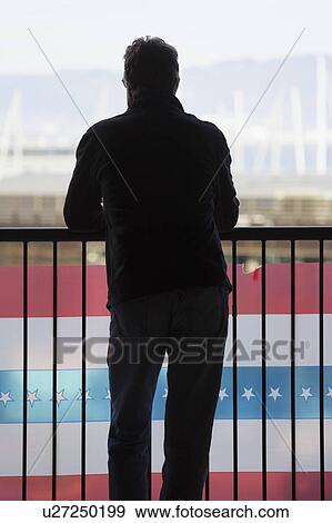 Stock Photo - San Francisco, California, USA, October 16, 2014, AT&T Park, baseball stadium, SF Giants versus St. Louis Cardinals, National League Championship Series (NLCS), silhouette of man with flag bunting. Fotosearch