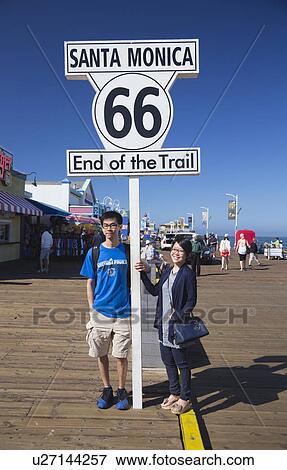 Santa Monica, California, USA 5/2/2015, asian couple pose at Route 66 sign Santa Monica Pier, end of famous Route 66 highway from Chicago View Large Photo Image Stock Photo - Santa Monica, California, USA 5/2/2015, asian couple pose at Route 66 sign Santa Monica Pier, end of famous Route 66 highway from Chicago. Fotosearch