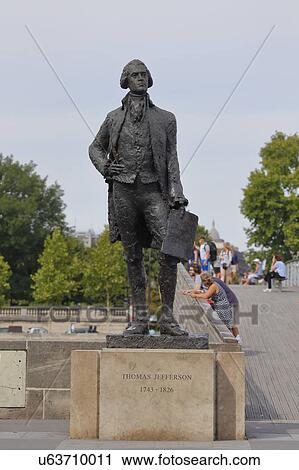 Stock Image - Statue of Thomas Jefferson, by JeanCardot shows him holdingarchitectural drawings of Monticello, Paris, France - Jefferson 1743 -1826 - shot August 2015. Fotosearch