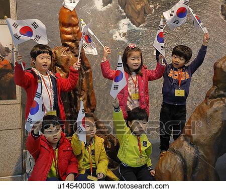 Stock Photo - Students wave Korean flags at War Memorial of Korea, Jeonjaeng ginyeomgwan, Yongsan-dong, Seoul, South Korea. Fotosearch