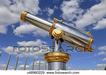 Stock Photo - Telescope View of Paris, France from top of Arch of Triumph on sunny day with clouds. Fotosearch