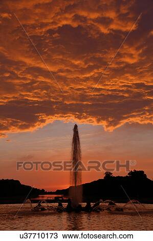 Stock Image - The Grand Canal Fountains of Chateau de Versailles at sunset, the estate of Versaille home of Louis XIV, France. Fotosearch