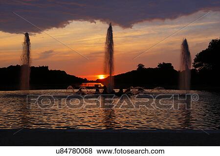 Stock Photo - The Grand Canal Fountains of Chateau de Versailles at sunset, the estate of Versaille home of Louis XIV, France. Fotosearch