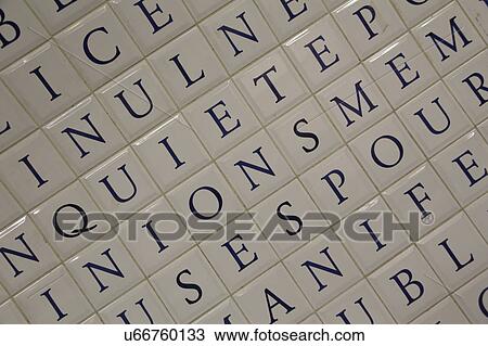Stock Image - Tile Letters on subway, underground wall, Paris France. Fotosearch