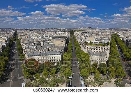 view of Paris, France as seen from the Arch of Triumph on a sunny day with white puffy clouds View Large Photo Image Stock Photo - view of Paris, France as seen from the Arch of Triumph on a sunny day with white puffy clouds. Fotosearch