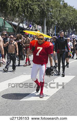 West Hollywood, Los Angeles, California, USA, June 14, 2015, 40th annual Gay Pride Parade for LGBT Community, down Santa Monica Blvd., football player with #7 jersey and yellow umbrella View Large Photo Image Stock Image - West Hollywood, Los Angeles, California, USA, June 14, 2015, 40th annual Gay Pride Parade for LGBT Community, down Santa Monica Blvd., football player with #7 jersey and yellow umbrella. Fotosearch