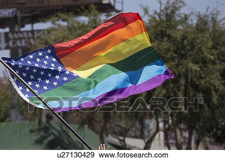 Stock Photo - West Hollywood, Los Angeles, California, USA, June 14, 2015, 40th annual Gay Pride Parade for LGBT Community, down Santa Monica Blvd., rainbow gay American flag flies. Fotosearch