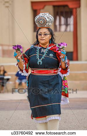 Zuni Indian Pueblo woman balances pot on her head in ceremony in Gallup, New Mexico View Large Photo Image Stock Image - Zuni Indian Pueblo woman balances pot on her head in ceremony in Gallup, New Mexico. Fotosearch