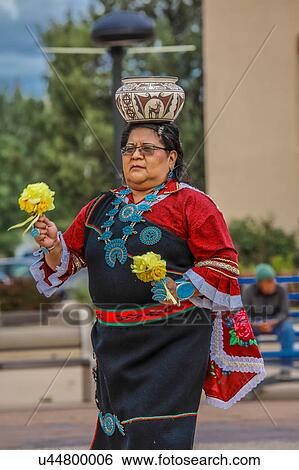 Stock Photograph - Zuni Indian Pueblo woman balances pot on her head in ceremony in Gallup, New Mexico. Fotosearch