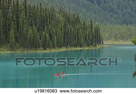 A boat on a lake, Rocky Mountains, Canada View Large Photo Image Stock Image - A boat on a lake, Rocky Mountains, Canada. Fotosearch